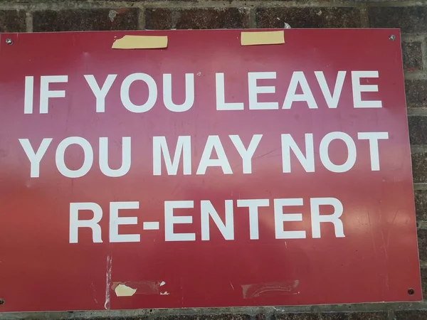 Red if you leave you may not re-enter sign on wall — 스톡 사진