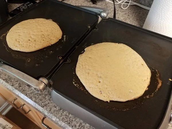 Pancake cooking on a griddle or stove — 스톡 사진