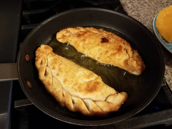 Puerto Rican pastry with cheese filling in oil — Photo