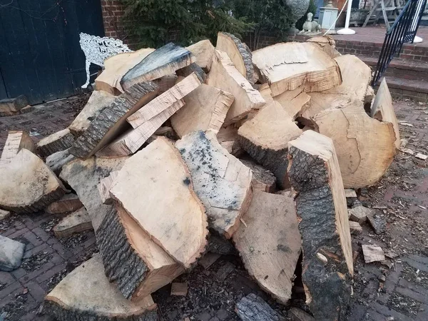 Chopped or cut firewood tree trunk or logs on bricks — Stok fotoğraf