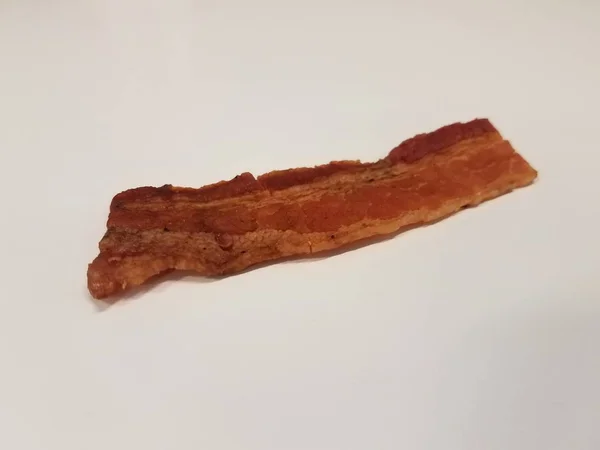 Bande de bacon ou de la viande sur la surface blanche ou table — Photo