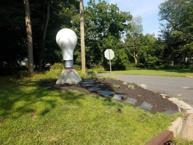 large light bulb and tiles and stree with grass