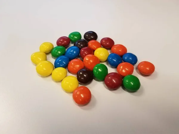 Colorful chocolate candy on white surface or table — 스톡 사진