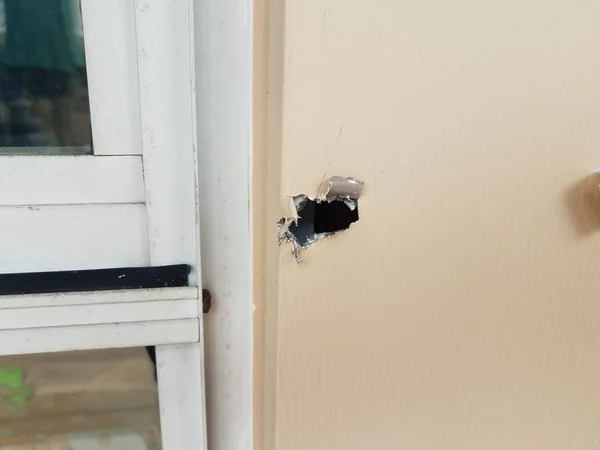 Gat in beschadigd metalen frame van raam op huis — Stockfoto