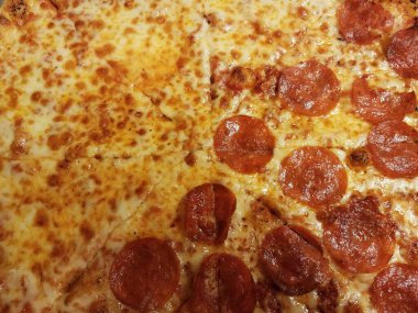 half cheese half pepperoni cheesy pizza slices