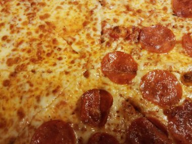 half cheese half pepperoni cheesy pizza slices