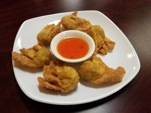 Fried wontons on plate with orange sweet and sour sauce — Stok fotoğraf