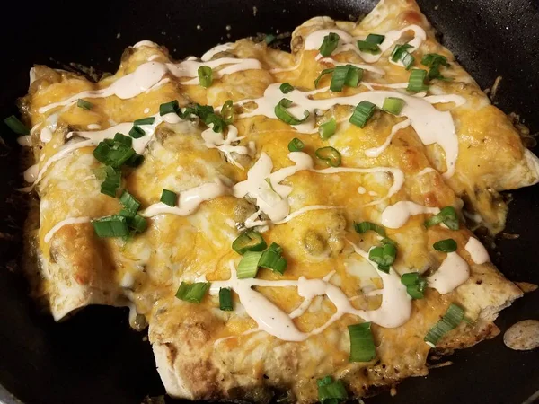 Enchiladas with cheese and onions and sauce in frying pan — Stock Photo, Image