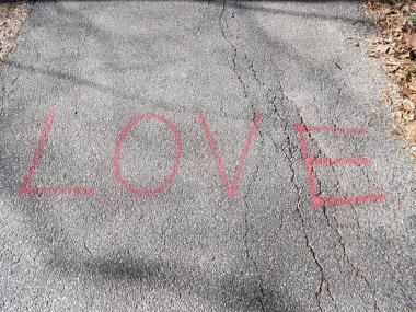 red love sign on asphalt trail or path