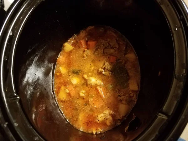 Cooking chicken and potato and carrot stew in pot — Stock Fotó