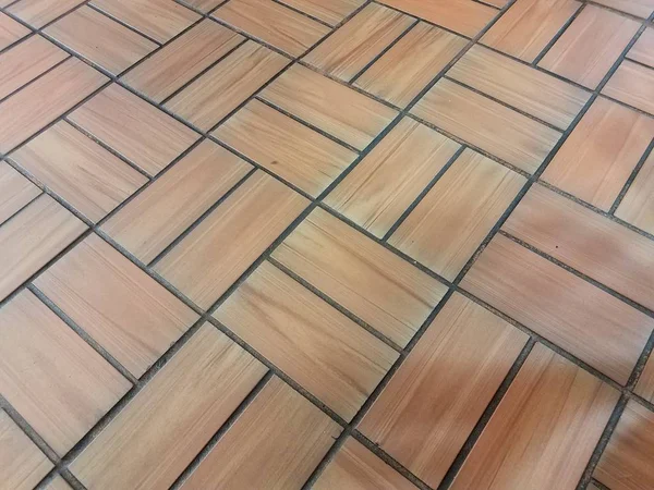 Brown brick rectangle tile pattern on floor or ground — Stockfoto