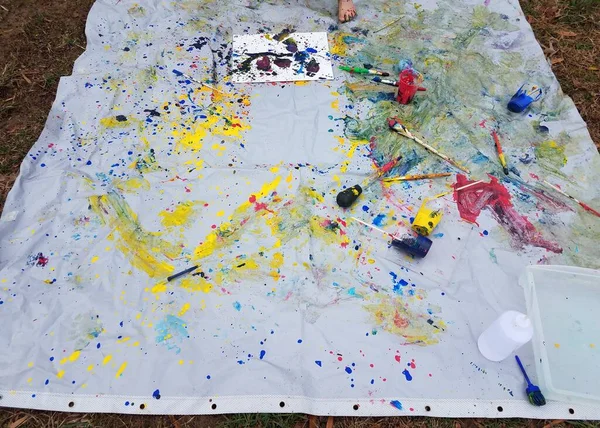 Shower curtain with paint splatter mess on ground — Stock Photo, Image