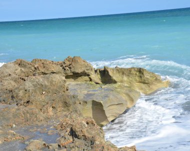 sand and rocks and ocean water at beach