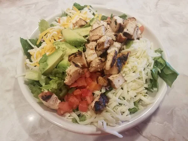 Bowl of salad with chicken and cheese and avocado — ストック写真
