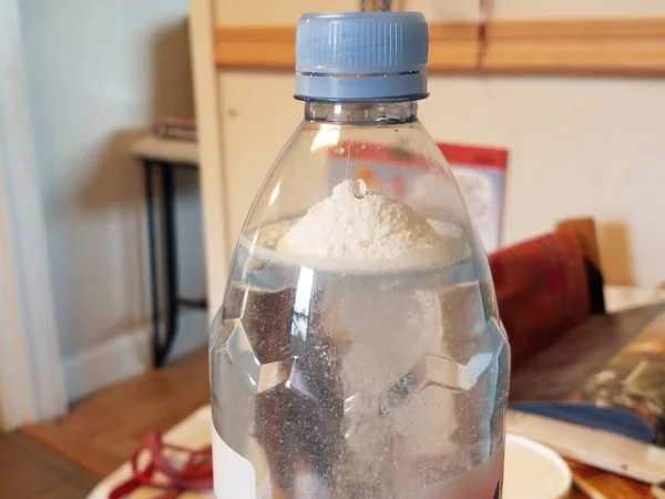 Protein powder dissolving in plastic water bottle — Stock Photo, Image