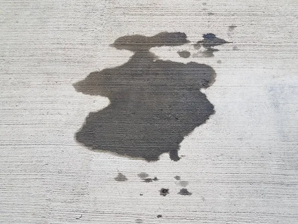 Oil stain or puddle on grey cement — 图库照片