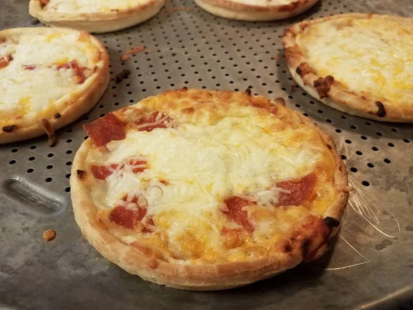 Pepperoni and cheese pizzas on metal baking tray — ストック写真