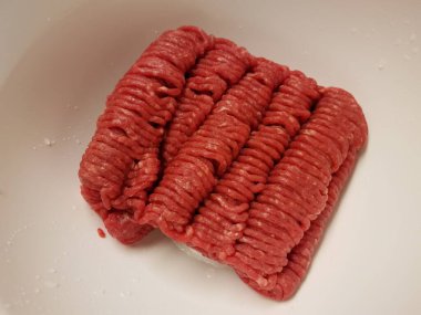 red ground beef meat in white bowl
