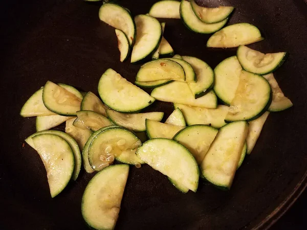 Zucchini slices and oil cooking in frying pan — Stockfoto