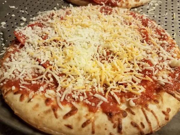 Pepperoni pizza with cheese on metal baking tray — Stock Photo, Image