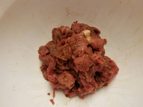 Kryddat rått nötkött i vitskål eller behållare — Stockfoto