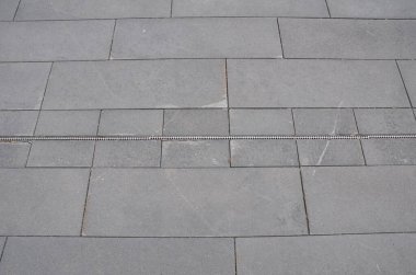 Yerdeki drenajı olan gri taş kiremitler