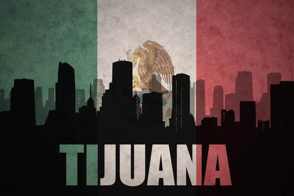 Abstract silhouet van de stad met tekst Tijuana op de Vintage Mexicaanse vlag — Stockfoto