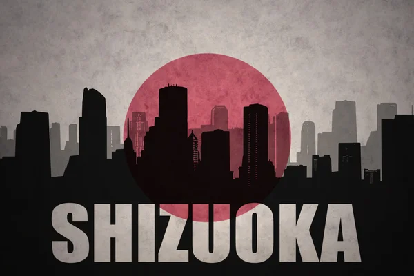 Silhueta abstrata da cidade com texto Shizuoka no fundo da bandeira japonesa vintage — Fotografia de Stock