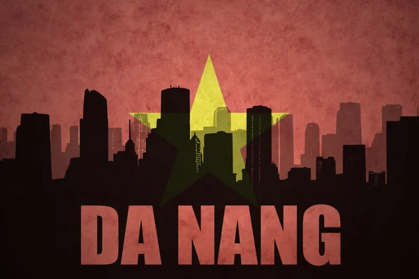 Abstract silhouette of the city with text Da Nang at the vintage vietnamese flag background — Stock Photo, Image