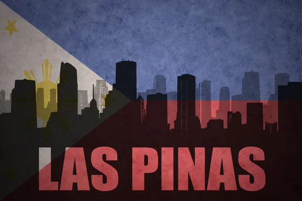 Abstract silhouette of the city with text Las Pinas at the vintage philippines flag background — Stock Photo, Image