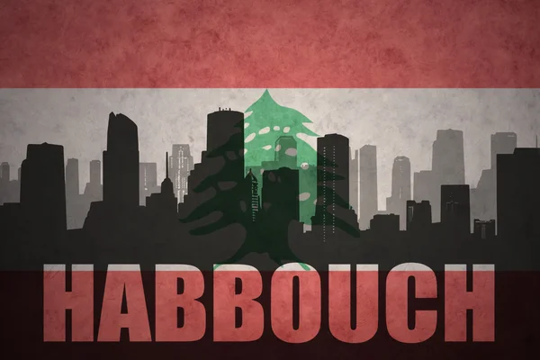 Abstrato silhueta da cidade com texto Habbouch no vintage lebanon bandeira fundo — Fotografia de Stock