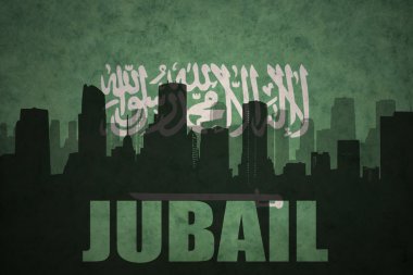 abstract silhouette of the city with text Jubail at the vintage saudi arabia flag background clipart