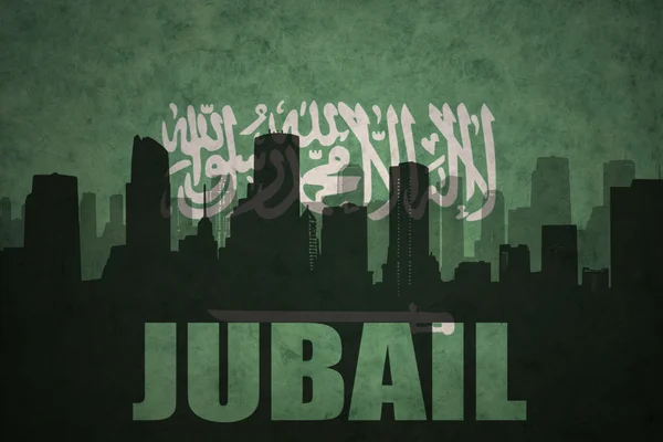 Abstrato silhueta da cidade com texto Jubail no vintage saudi arabia bandeira fundo — Fotografia de Stock