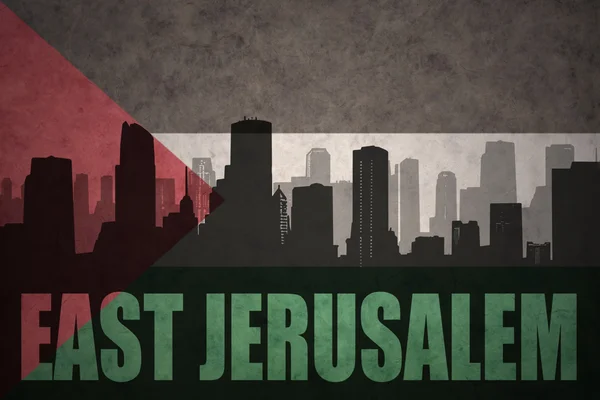 Abstract silhouette of the city with text East Jerusalem at the vintage palestinian flag background — Stock Photo, Image