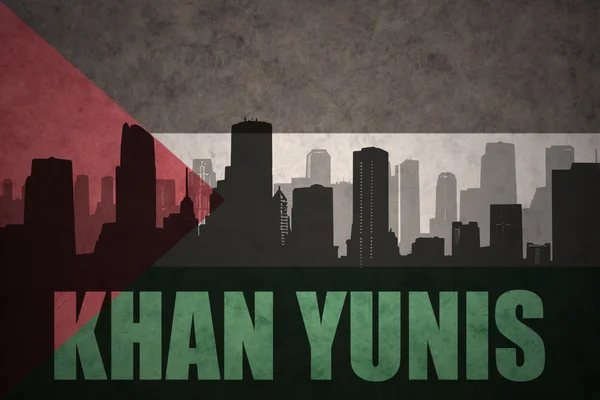 Abstract silhouette of the city with text Khan Yunis at the vintage palestinian flag background — Stock Photo, Image