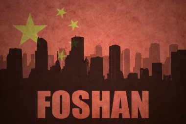 abstract silhouette of the city with text Foshan at the vintage chinese flag background clipart