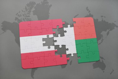 bir dünya haritası arka plan üzerinde avusturya ve madagaskar ulusal bayrağı ile bulmaca.
