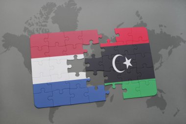 bir dünya haritası arka plan üzerinde Hollanda ve Libya ulusal bayrağı ile bulmaca.