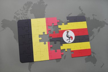 bir dünya haritası arka plan üzerinde Belçika ve Uganda ulusal bayrağı ile bulmaca.
