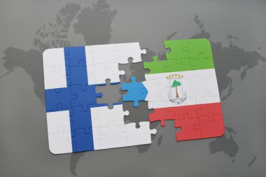 bir dünya haritası arka plan üzerinde finlandiya ve ekvator ginesi ulusal bayrağı ile bulmaca.