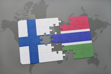 bir dünya haritası arka plan üzerinde Finlandiya ve gambiya ulusal bayrağı ile bulmaca.