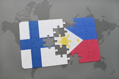 bir dünya haritası arka plan üzerinde Finlandiya ve Filipinler ulusal bayrağı ile bulmaca.