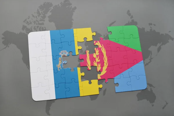 Puzzle con la bandiera nazionale delle isole canarie ed eritrea su sfondo mappa del mondo . — Foto Stock