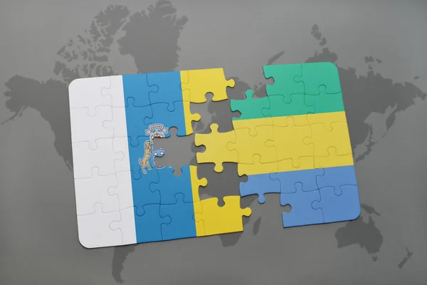 Puzzle con la bandiera nazionale delle isole canarie e gabon su uno sfondo mappa del mondo . — Foto Stock