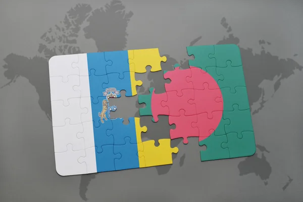Puzzle with the national flag of canary islands and bangladesh on a world map background. — Stock Photo, Image