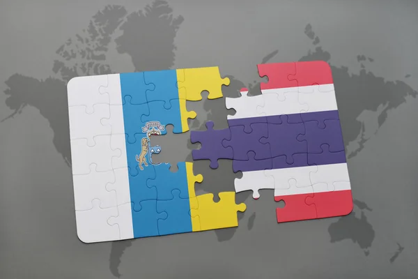 Puzzle with the national flag of canary islands and thailand on a world map background. — Φωτογραφία Αρχείου