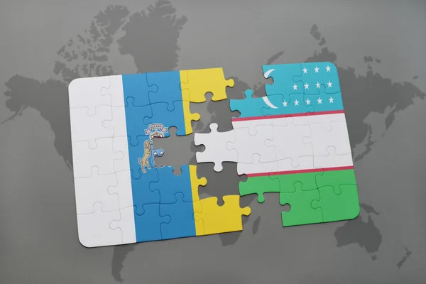 益智与世界地图背景上的加那利群岛和乌兹别克斯坦国旗. — 图库照片