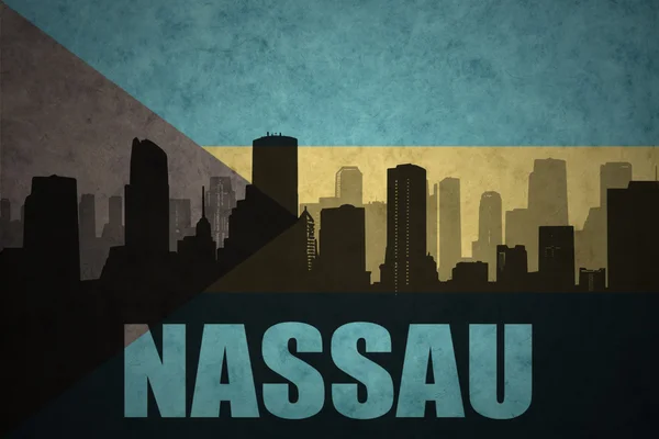 Abstract silhouette of the city with text Nassau at the vintage bahamas flag — ストック写真