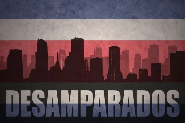 Абстрактный силуэт города с текстом Desamparados на винтажном флаге Коста-Рики — стоковое фото