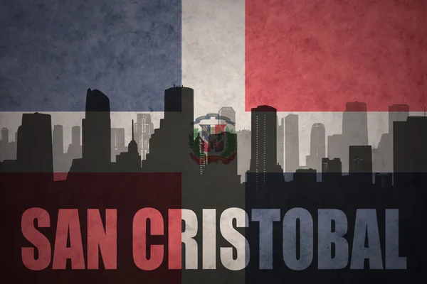 Abstracte silhouet van de stad met tekst San Cristobal op de vintage vlag van de Dominicaanse Republiek — Stockfoto